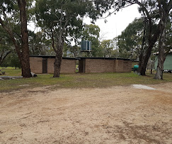 Open camp area with gum trees and camping sites